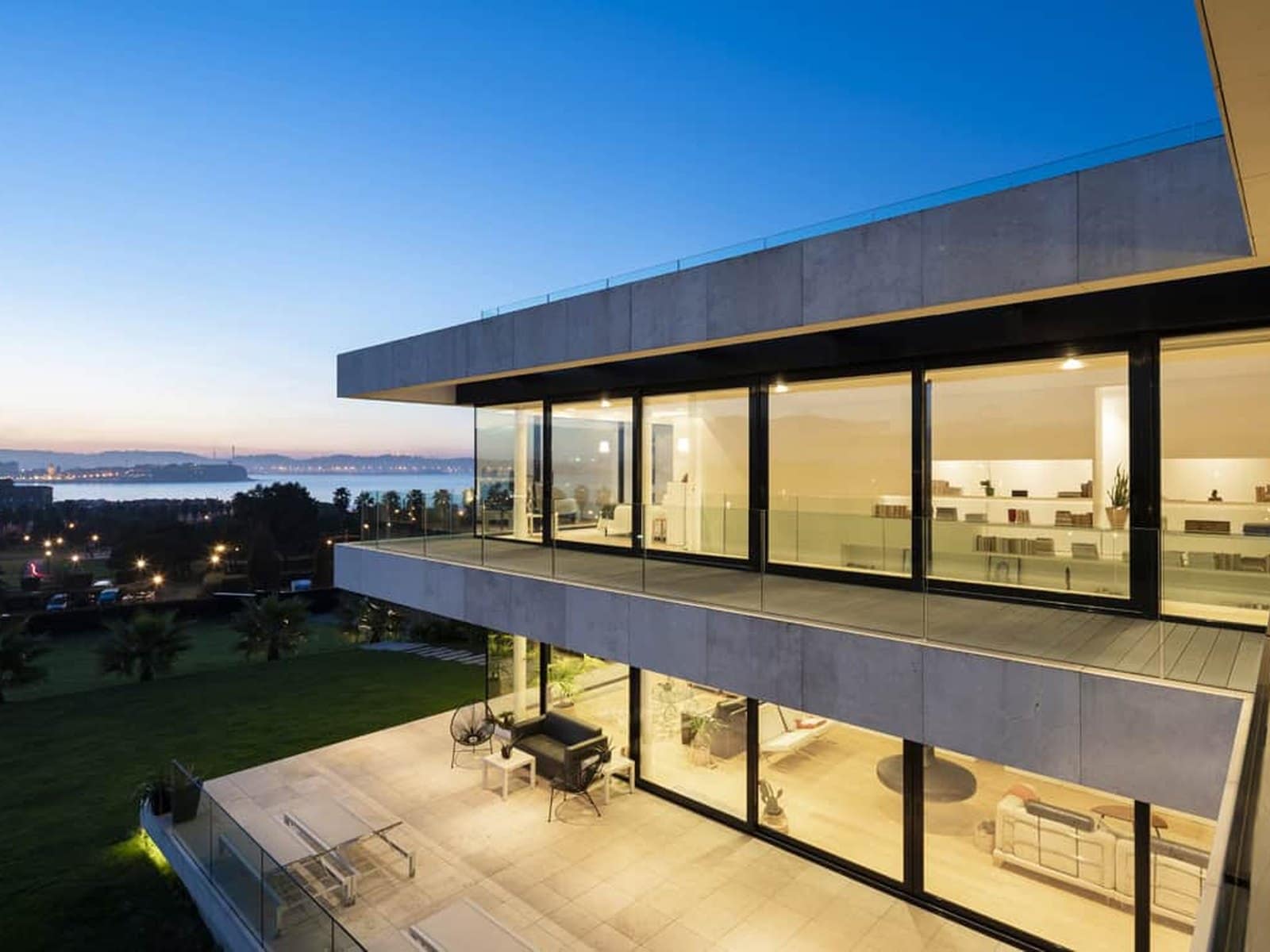 A modern two-storey elevation glazed with slim-framed sliding doors